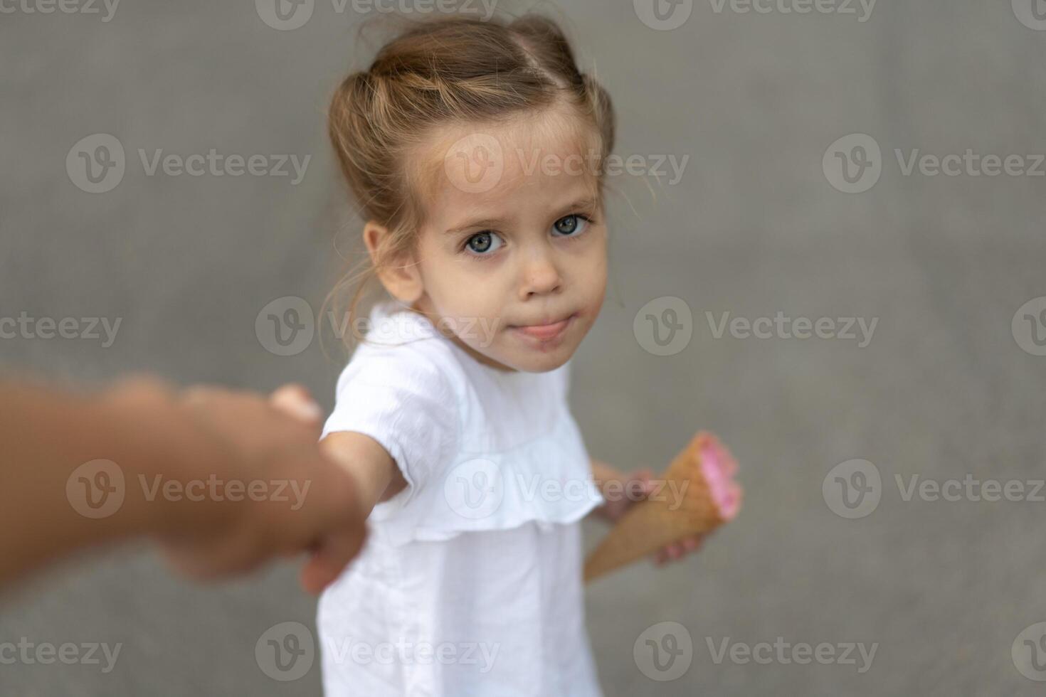 weinig Kaukasisch meisje 3 jaren oud eet ijs room detailopname portret foto