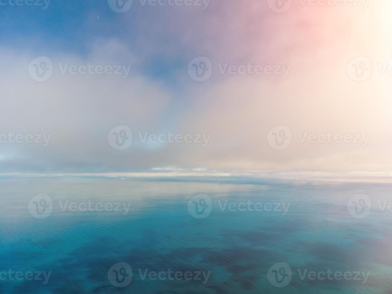 abstract antenne natuur zomer oceaan zonsondergang zee en lucht achtergrond. klein golven Aan Doorzichtig water oppervlakte in beweging vervagen met bokeh lichten van zonsopkomst. vakantie, vakantie en recreatief banier concept foto