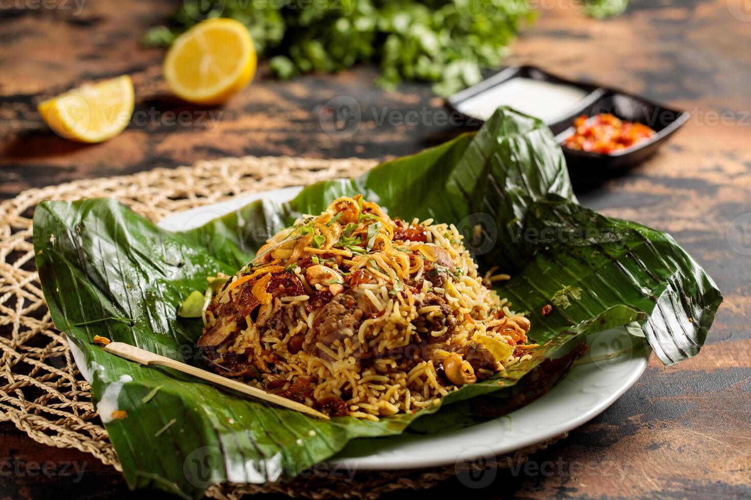 kip biryani inpakken in banaan blad geserveerd in schotel geïsoleerd Aan tafel top visie van Arabisch ontbijt foto