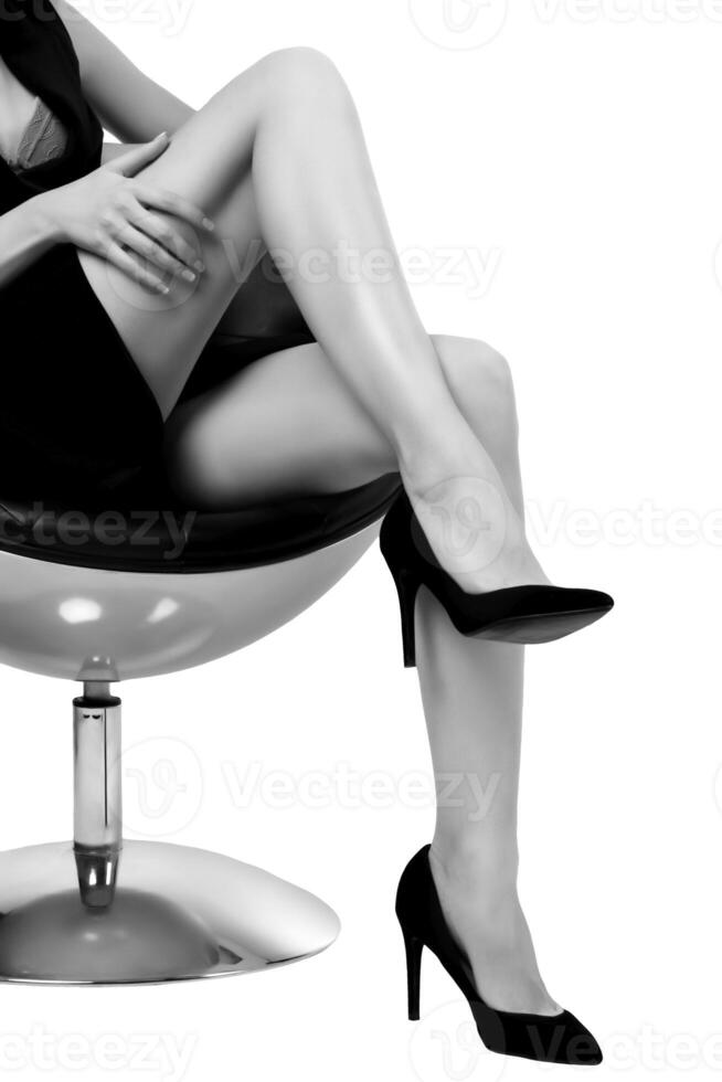 vrouw met lang poten zittend in een stoel, geïsoleerd Aan wit achtergrond foto