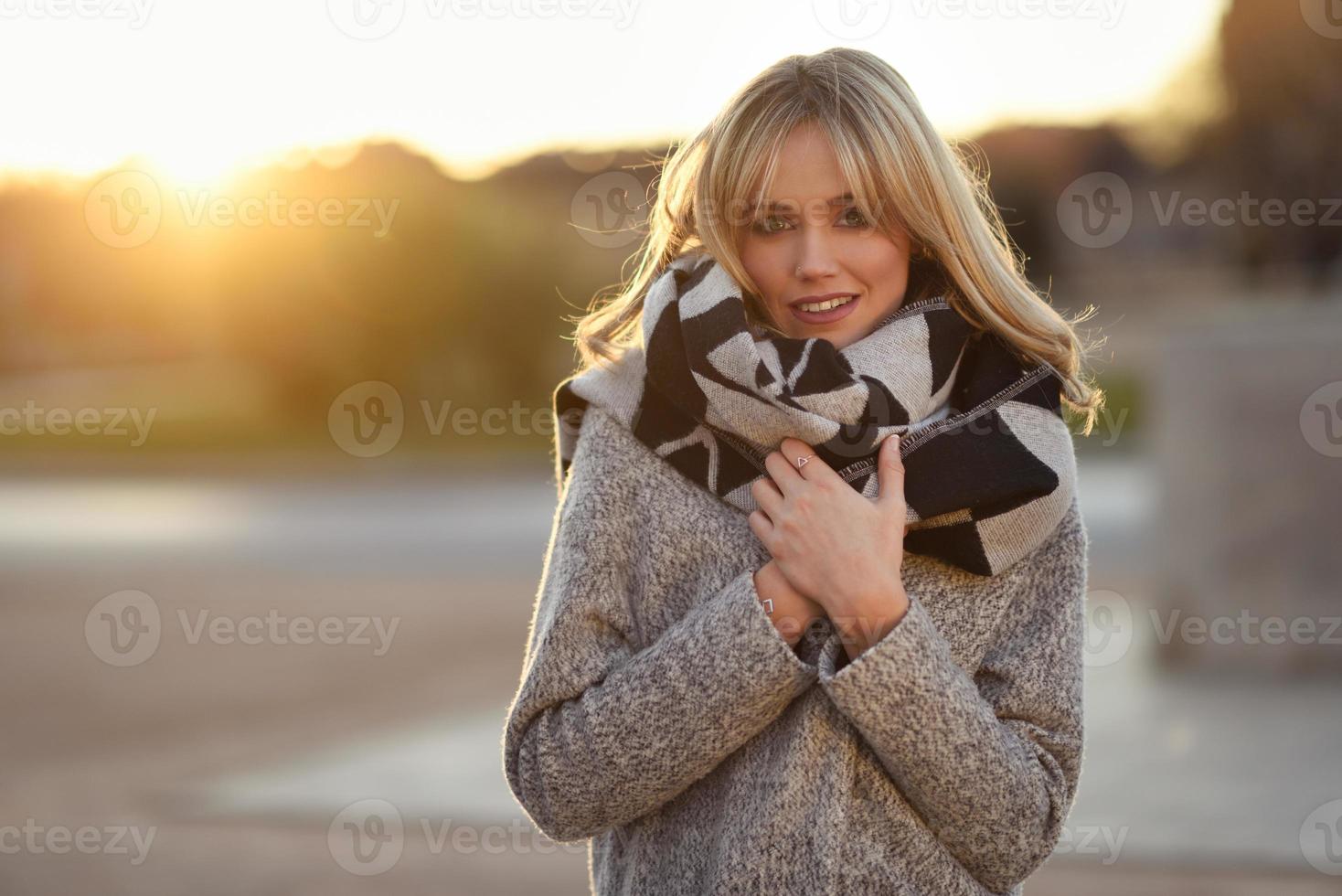 mooie jonge blonde vrouw in stedelijke achtergrond foto