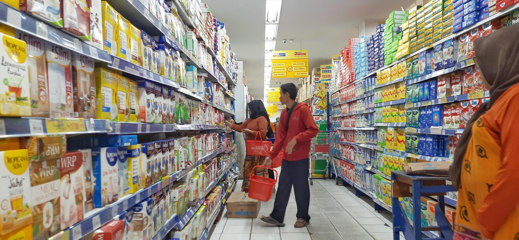 klant kiezen divers boodschappen producten in kruidenier op te slaan. supermarkt concept. bekasi, west Java, Indonesië - maart 8 2024 foto
