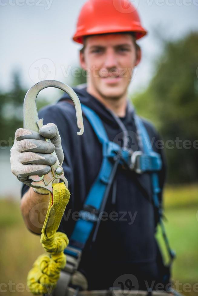 technicus man in veiligheidshelm met veiligheidshaak. foto