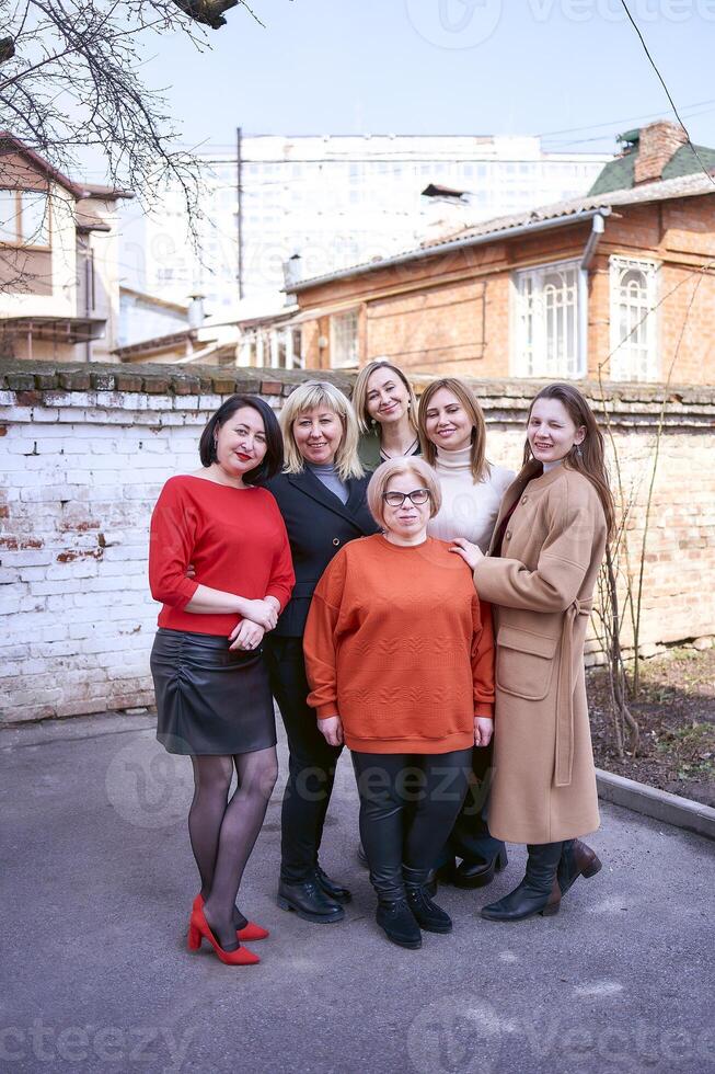 een team van Dames werken samen buiten de kantoor Aan een voorjaar dag foto