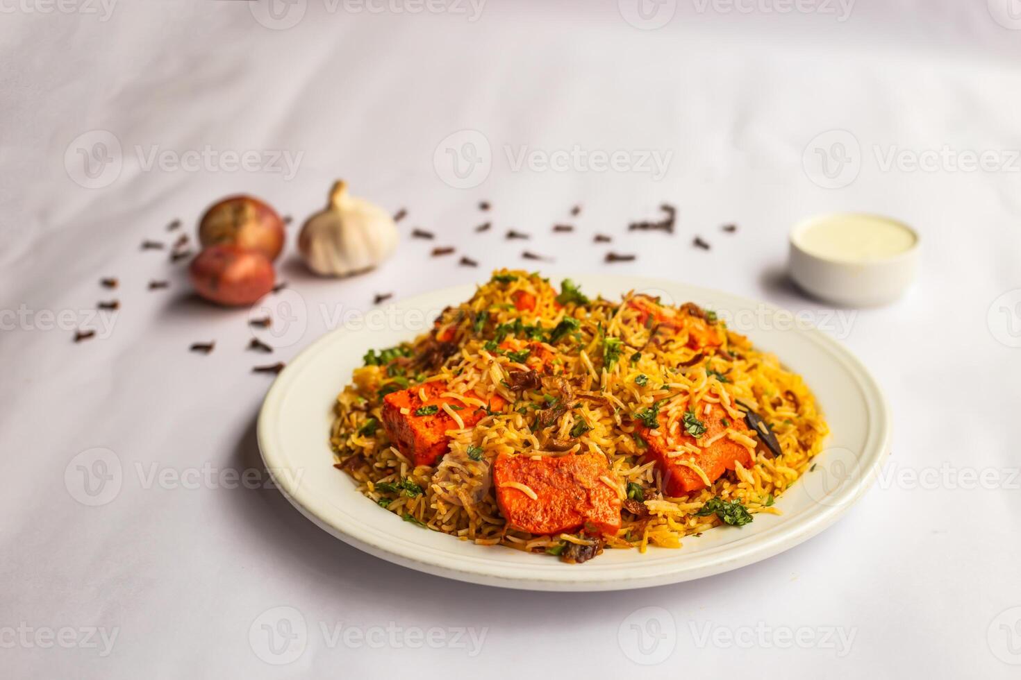 mughlai paneer tikka biryani rijst- Pulao met knoflook, ui en raita geserveerd in bord geïsoleerd Aan achtergrond kant visie van Indisch en Pakistaans traditioneel voedsel foto