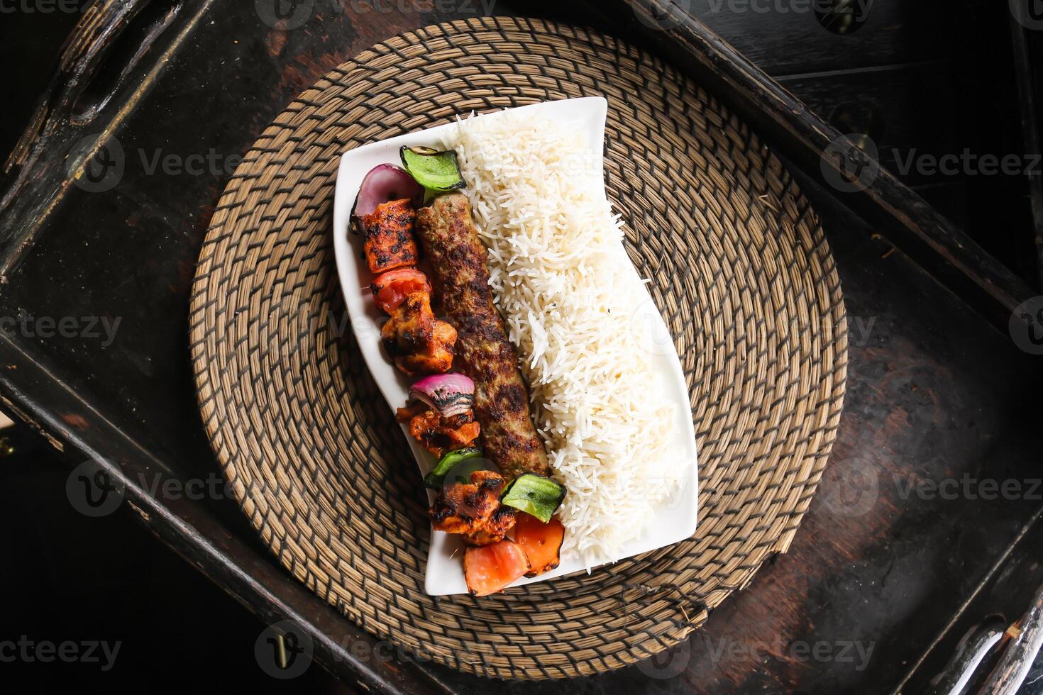 chelo kabab of chello kebab met kip tikka en rijst- geserveerd in schotel geïsoleerd Aan rood mat top visie Aan tafel Arabisch voedsel foto