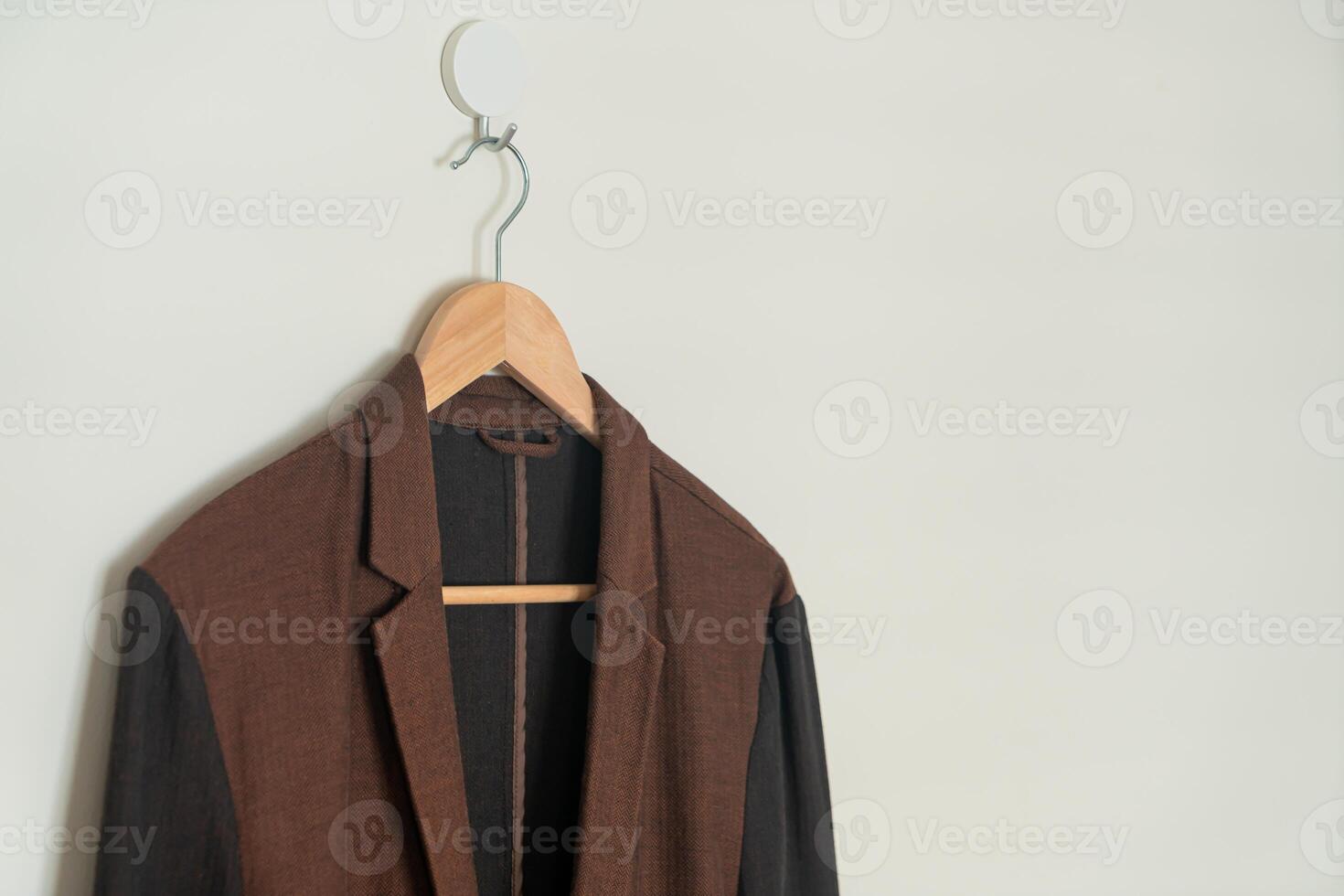 beige pak hangend met houten hanger foto