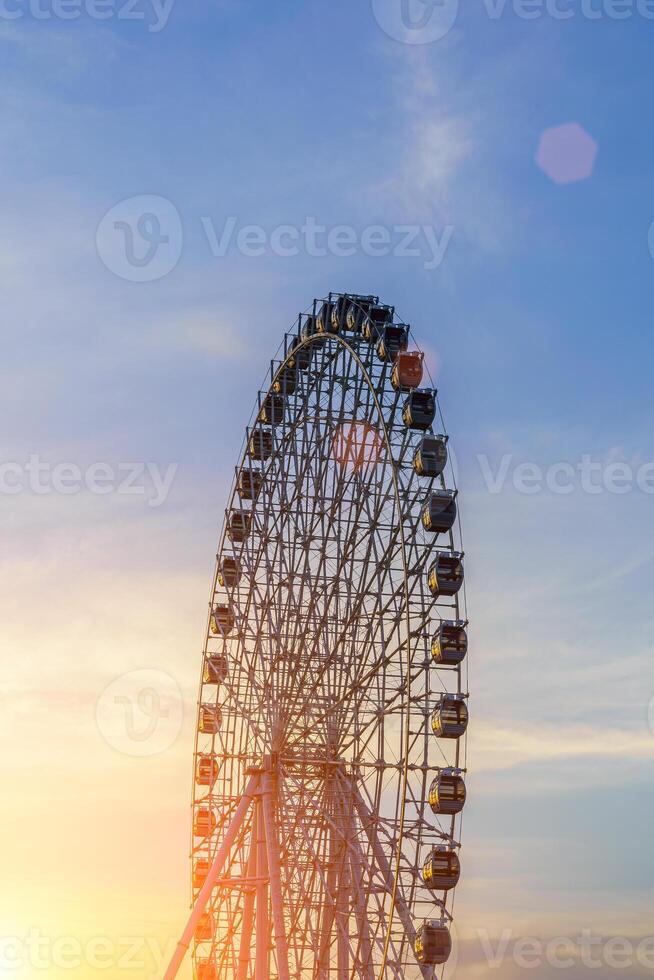 hoog ferris wiel Bij zonsondergang of zonsopkomst met bewolkt lucht achtergrond. foto