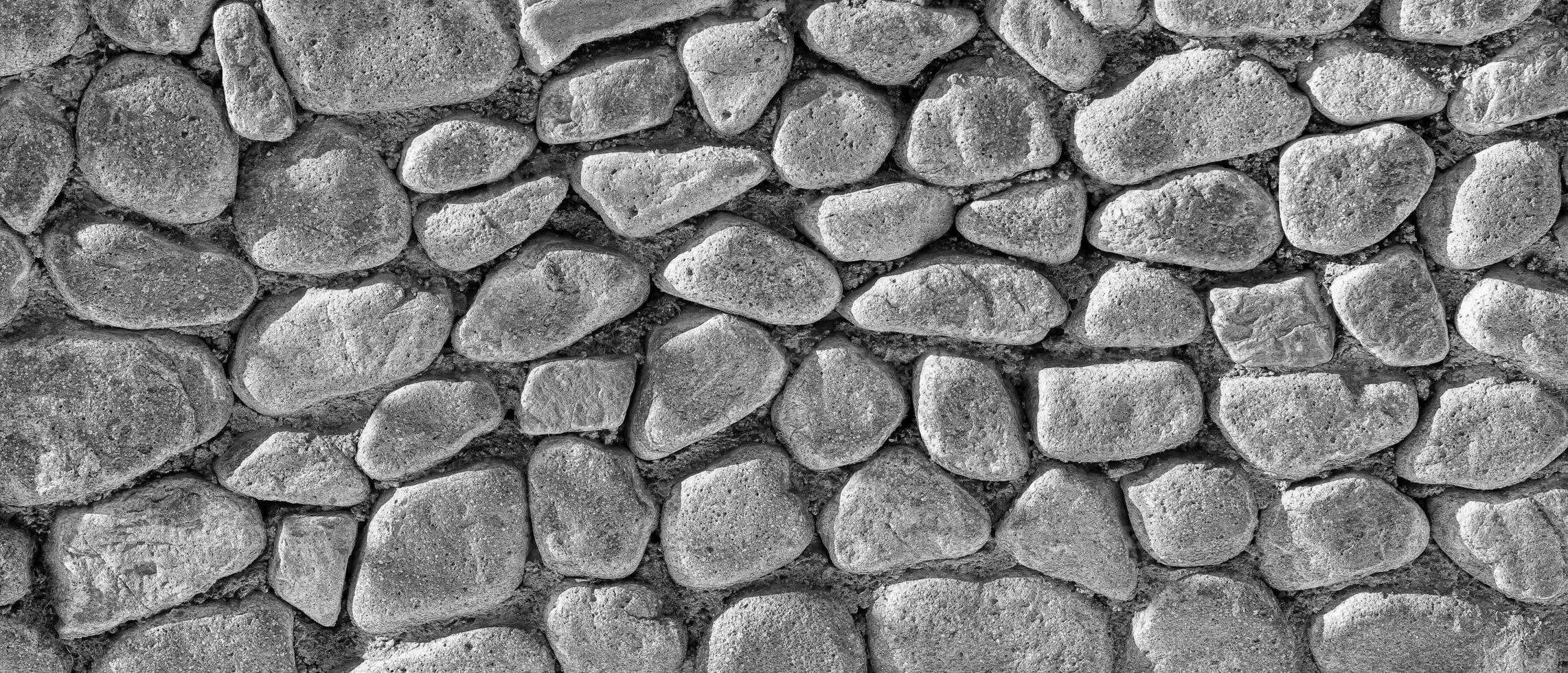 zwart en wit structuur van een oud antiek steen muur. abstract achtergrond. foto
