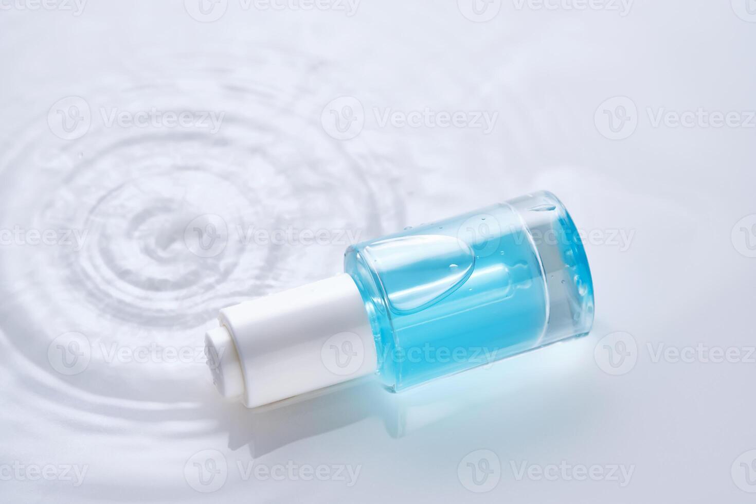 flessen van serum met een druppelaar in vloeistof met parel tinten. foto