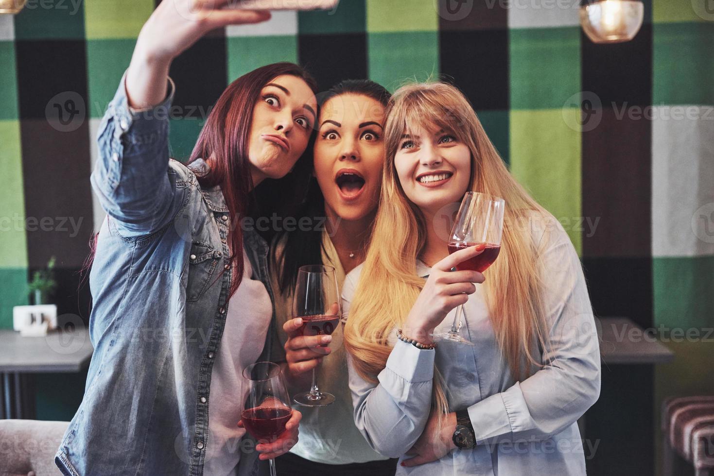 foto presenteren gelukkige groep vrienden met rode wijn selfie te nemen