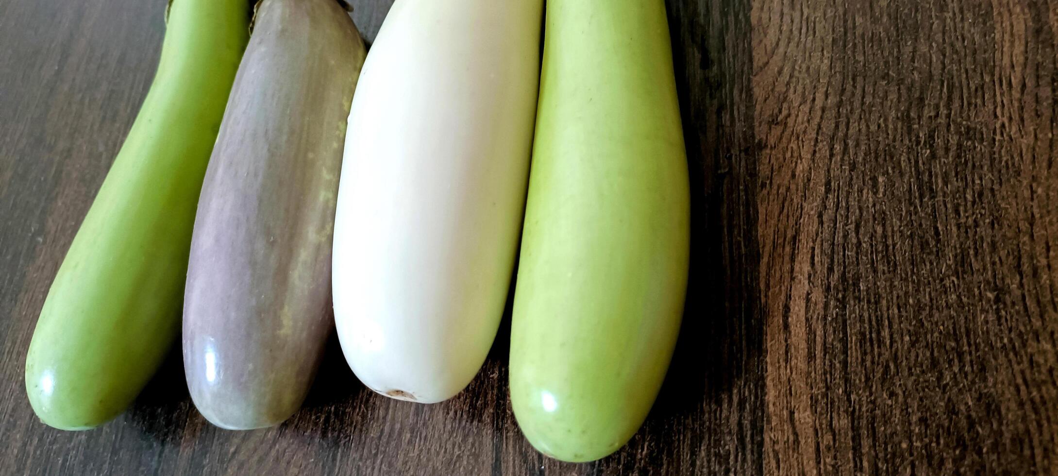 detailopname van biologisch wit en groen vers aubergine of eierplant geïsoleerd Aan houten achtergrond foto