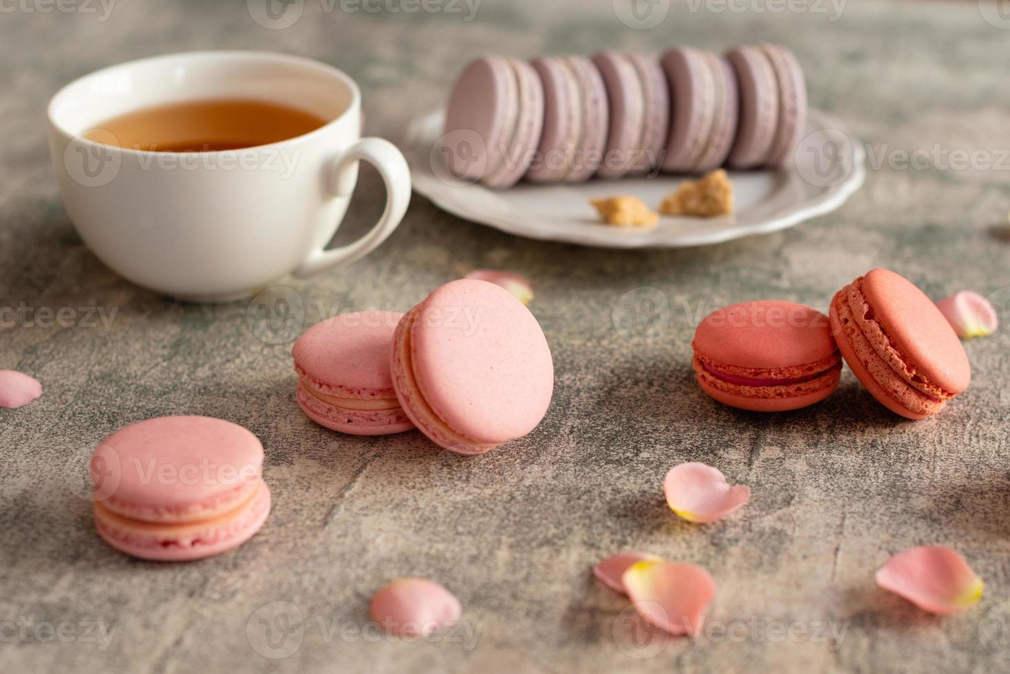 mooie roze smakelijke bitterkoekjes op een betonnen ondergrond foto