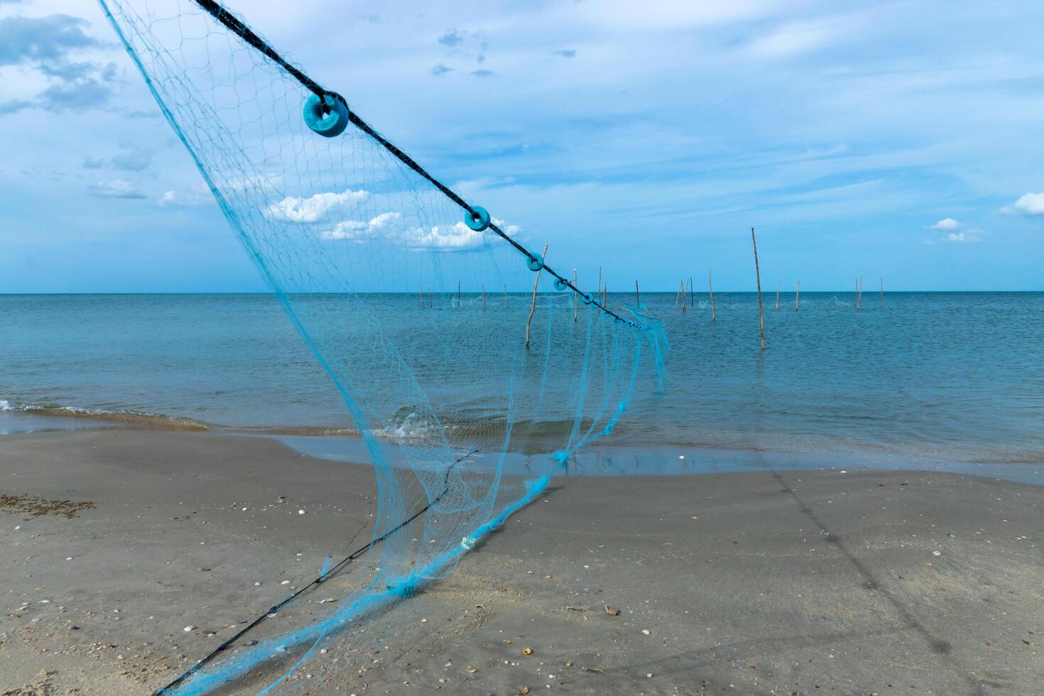 visvangst netto Aan de stranden foto