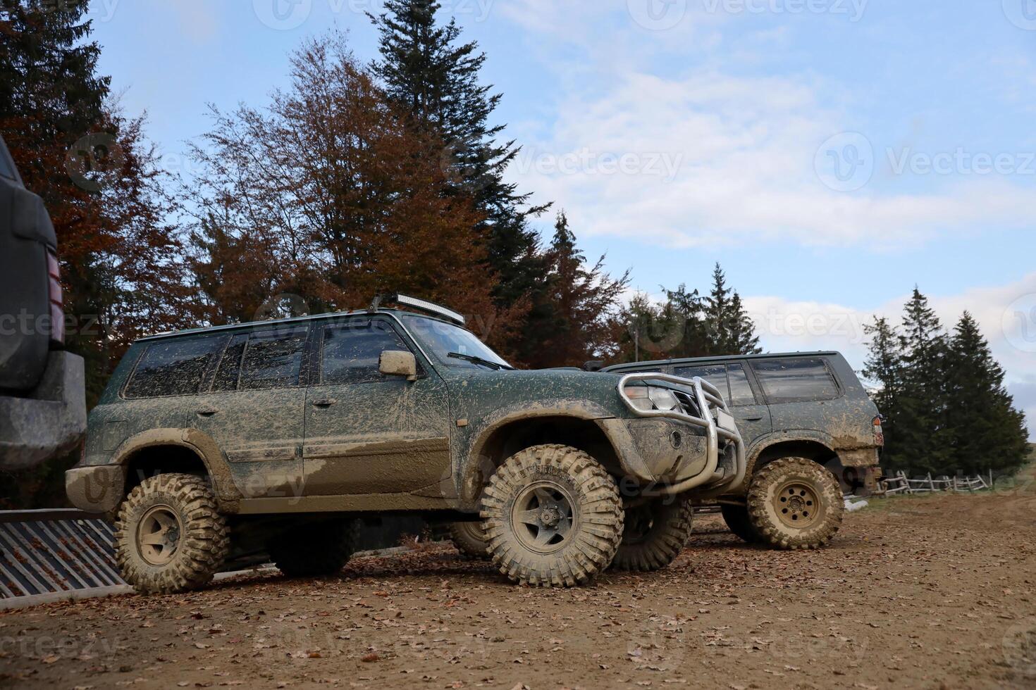 auto- in een platteland landschap met een modder weg. van de weg af 4x4 suv auto- met ditry lichaam na rit in modderig weg foto