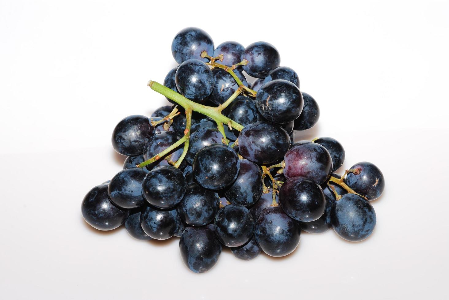 blauwe druiven van bovenaf met witte achtergrond foto