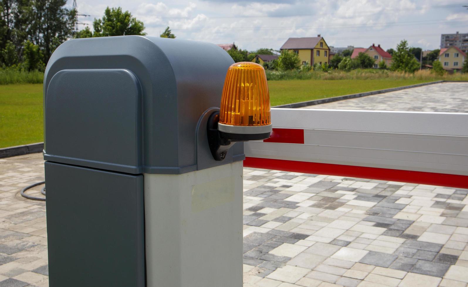 sluit de poort. automatisch beveiligingssysteem. automatisch invoersysteem. geel lichtsignaal met een straatbarrière. slagbomen automatisch beveiligingssysteem. foto