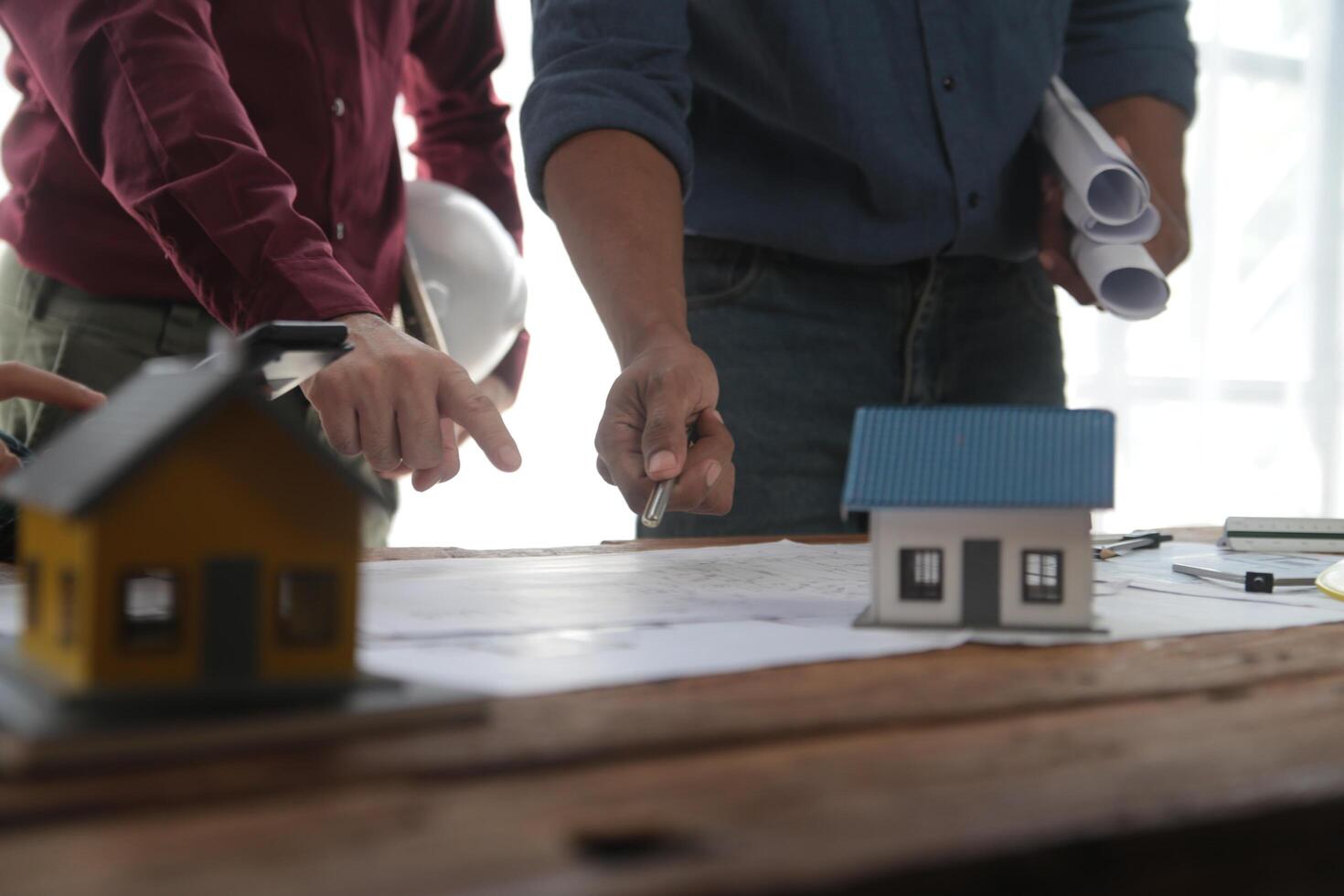 verschillend team van specialisten gebruik laptop Aan bouw plaats. echt landgoed gebouw project met ingenieur investeerder en zakenman controle Oppervlakte, werken Aan civiel engineering, bespreken strategie plan foto