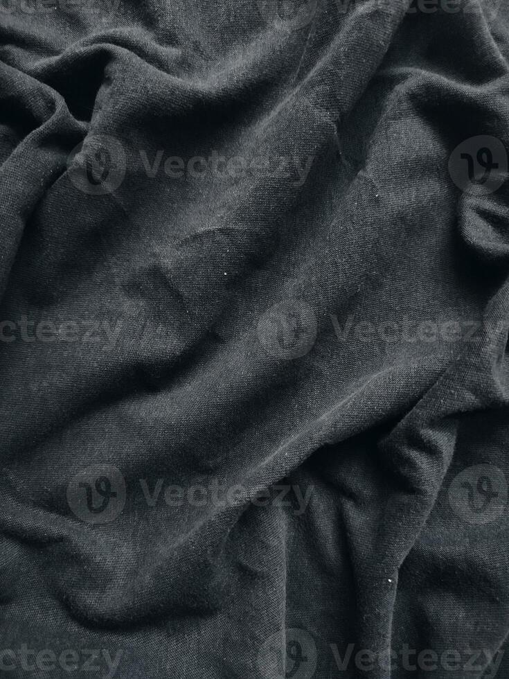 de structuur en achtergrond van de kleding stof zijn zwart foto