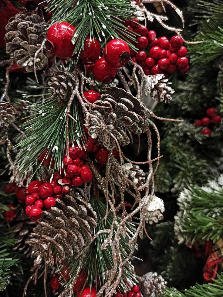 kerstboom met versieringen en rode bessen. kerst achtergrond foto