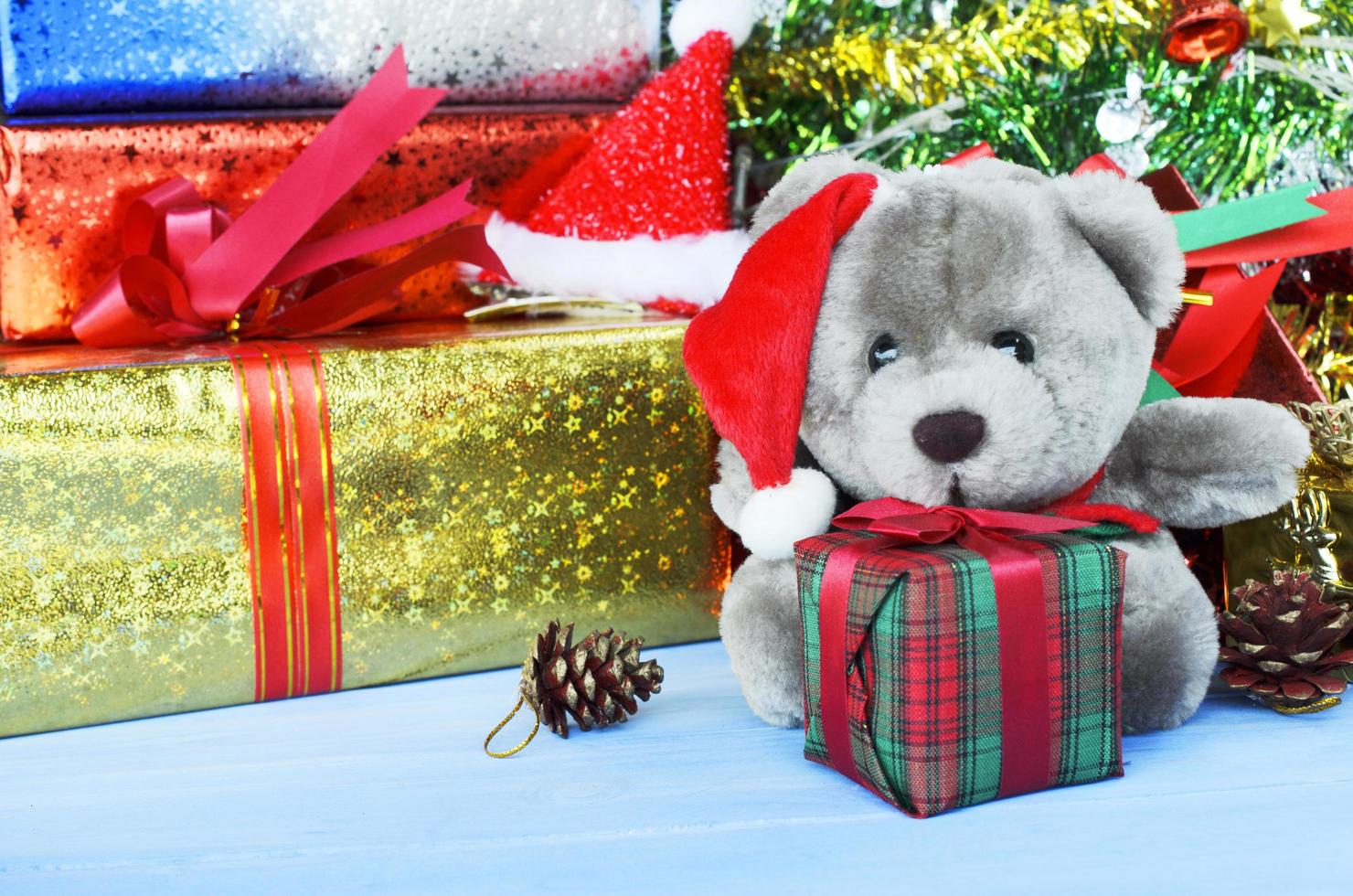 teddy pop met kerstmuts en geschenkdoos en kerstversiering achtergronden foto