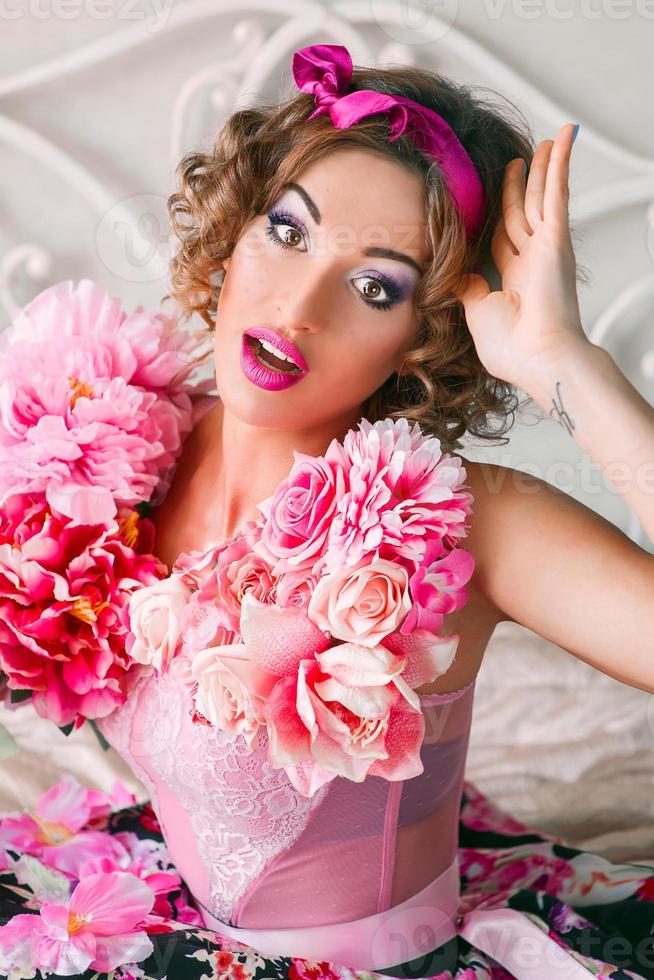 portret van een jonge vrouw in een kleurrijke jurk met bloemen erop in poppenstijl foto