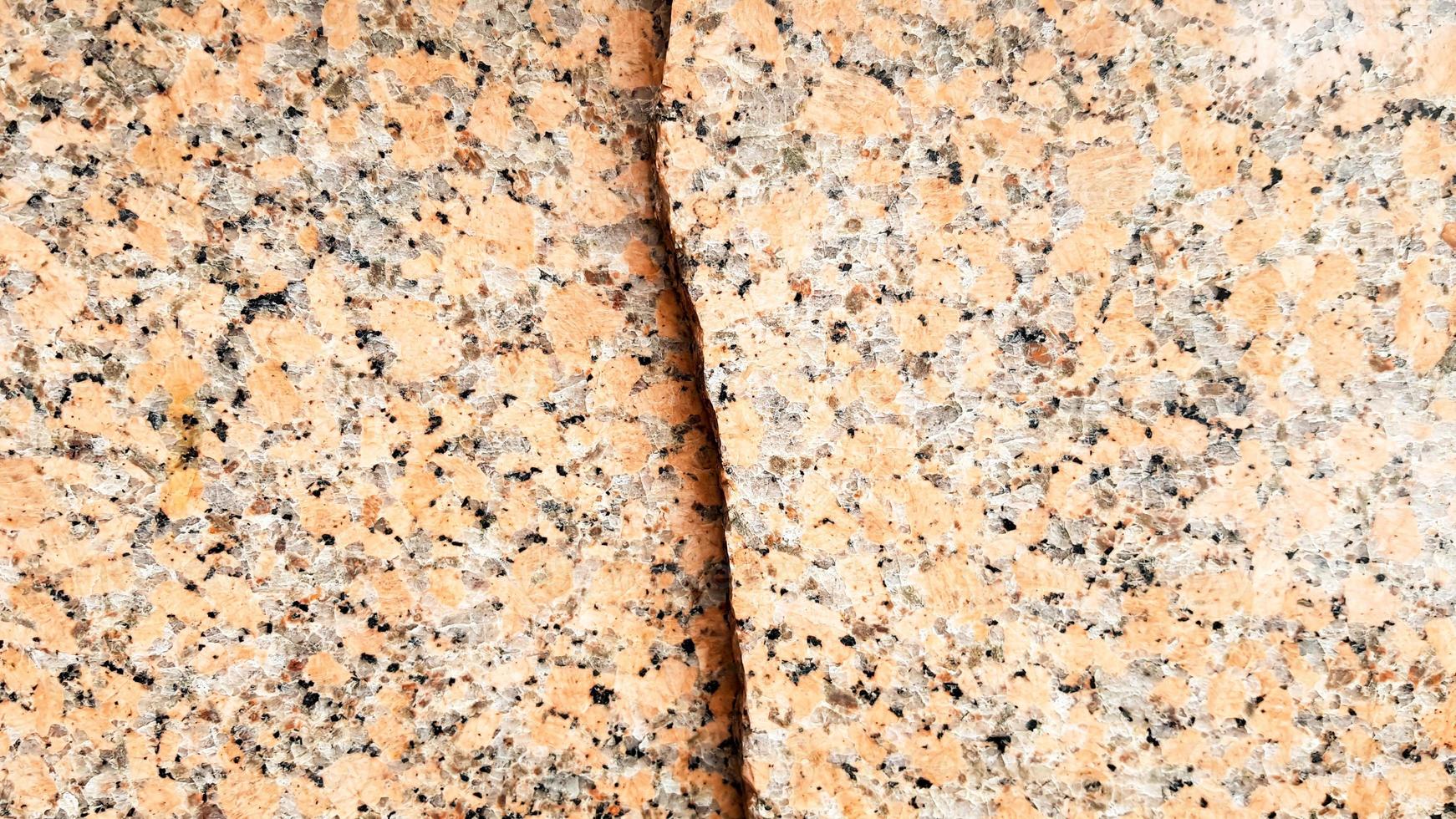 echt natuurlijk bruin granietpatroon, gepolijste minerale plak. naadloze gebarsten marmer beschadigd beton textuur. architecturale achtergrond. bruine vlekken op een stenen achtergrond. marmering foto
