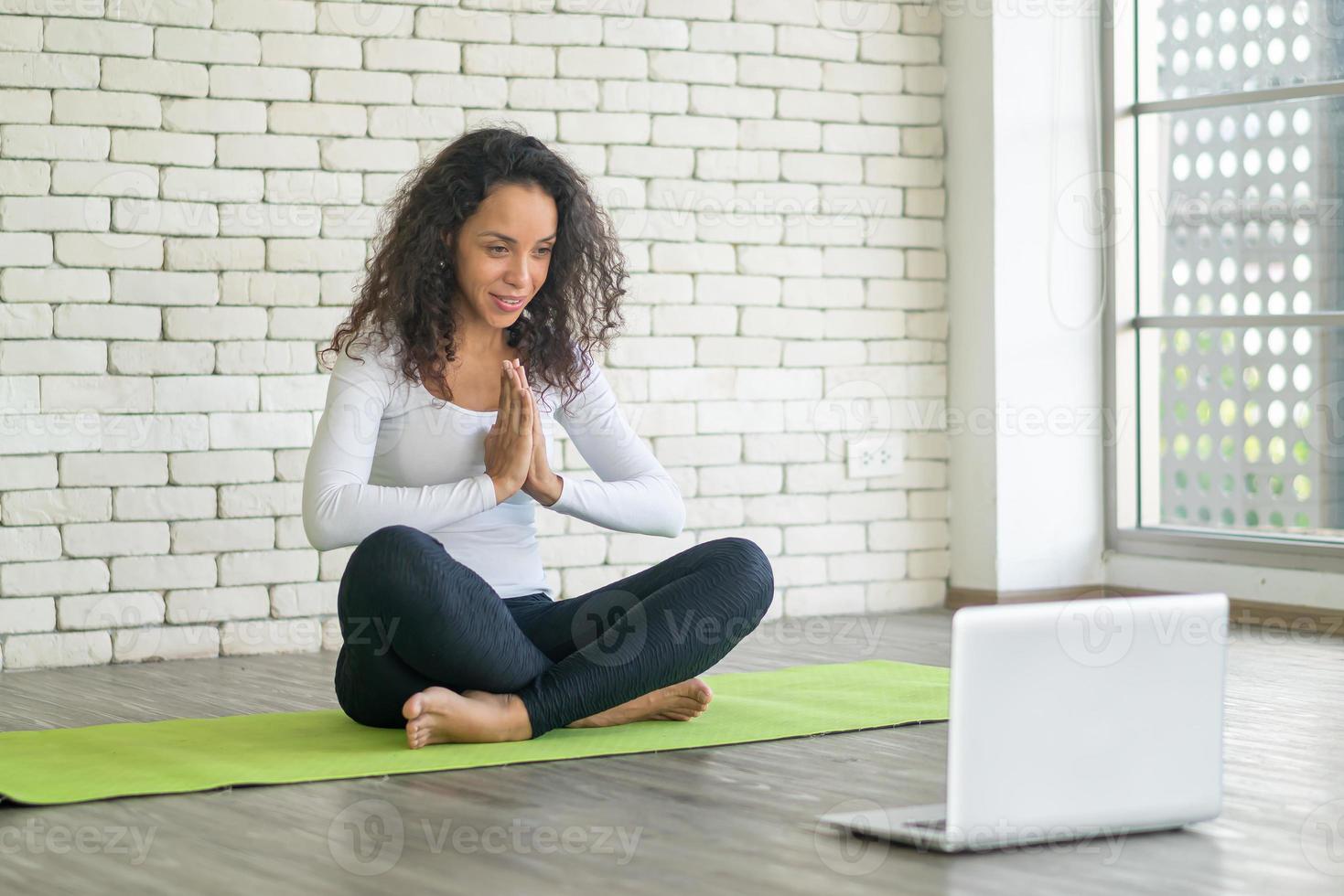 Latijnse vrouw die yoga online geeft foto