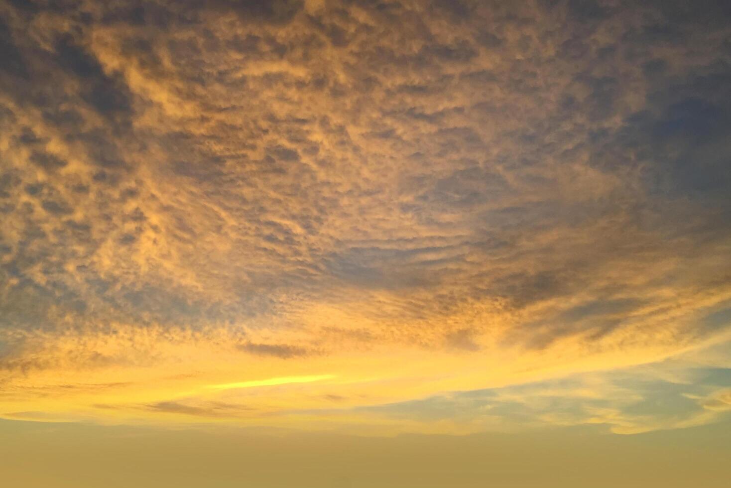 schitterende gele zonsondergang en zonsopgang mooi boven grijze wolken met felgele zon op een koele lenteavond. foto