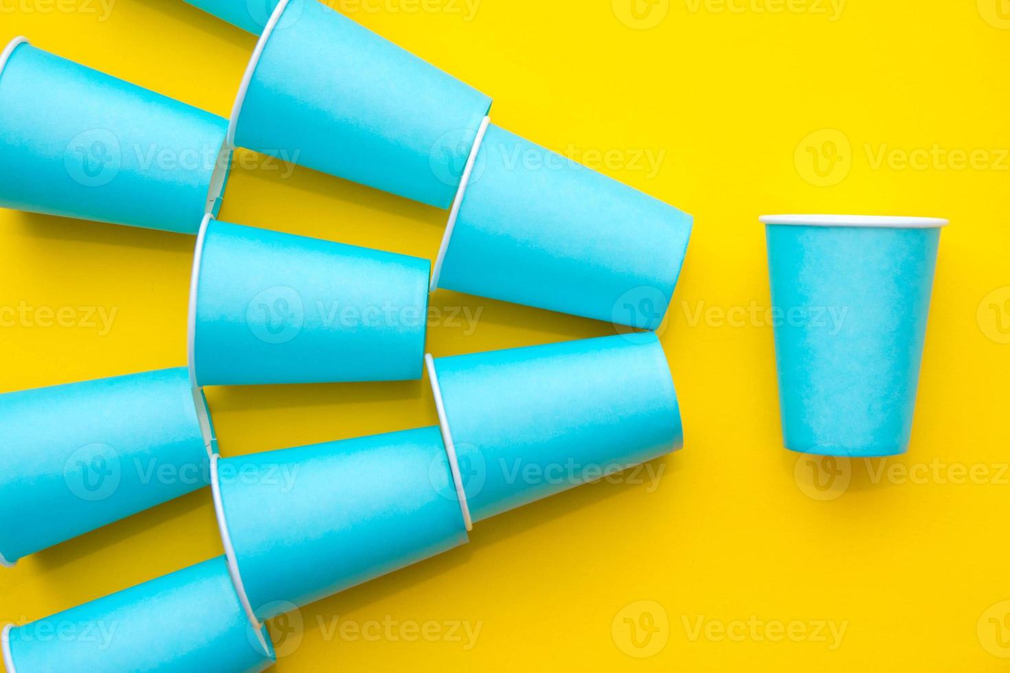 patroon van blauwe papieren wegwerpbekers op gele achtergrond foto
