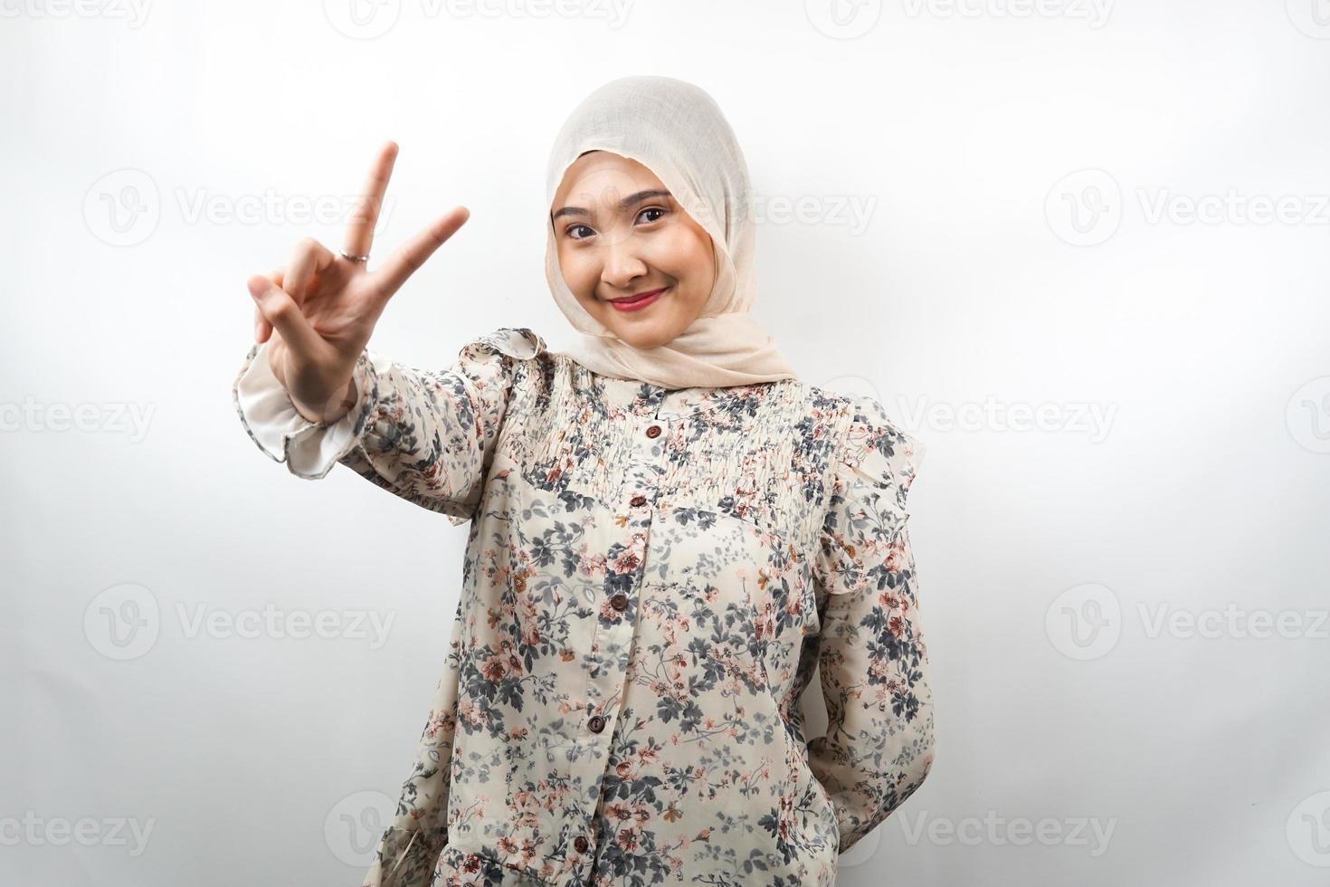 mooie jonge Aziatische moslimvrouw steenbolk met v-ondertekende handen, ok, goed gedaan, overeenkomst, overwinning, kijken naar camera geïsoleerd op witte achtergrond foto