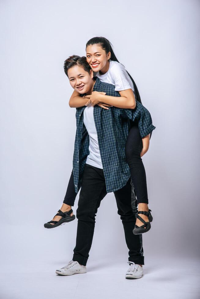 twee liefhebbende vrouwen droegen gestreepte shirts en reden op hun rug. foto