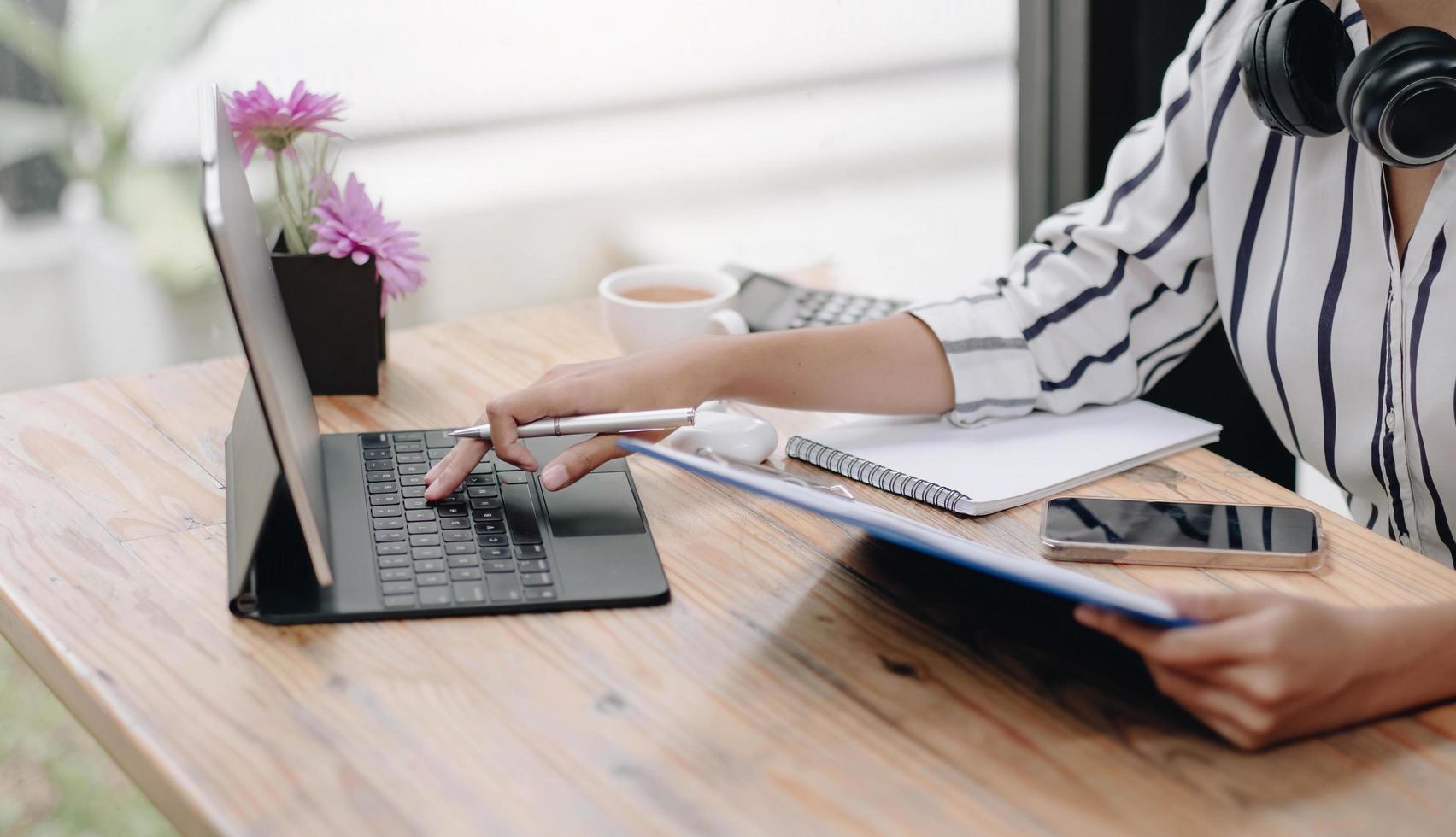 vrouwen met behulp van laptopcomputer en noteer wat gegevens op Kladblok. foto