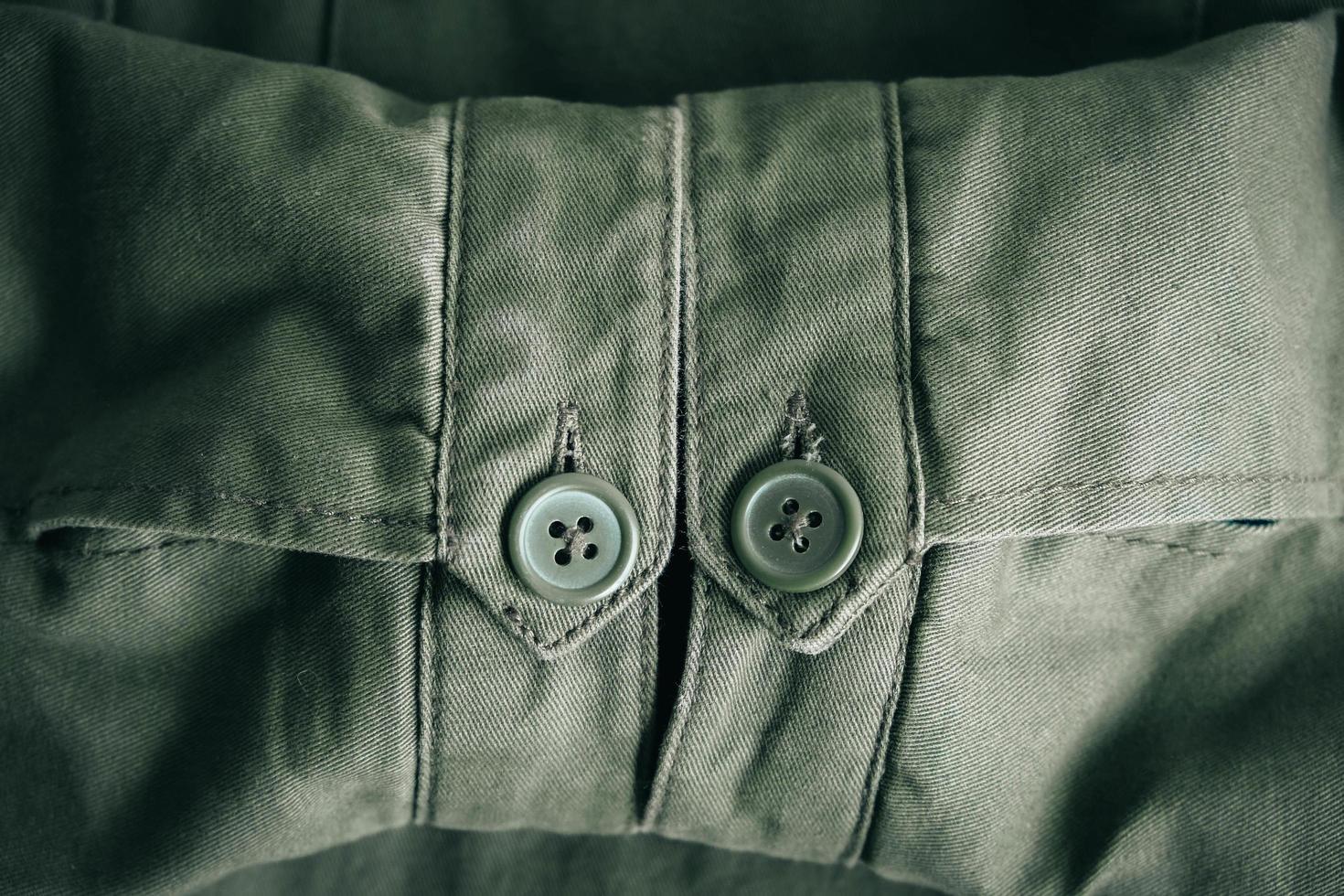 achtergrond van vouwmouwen van groen jasje en knopen met naadlijn foto