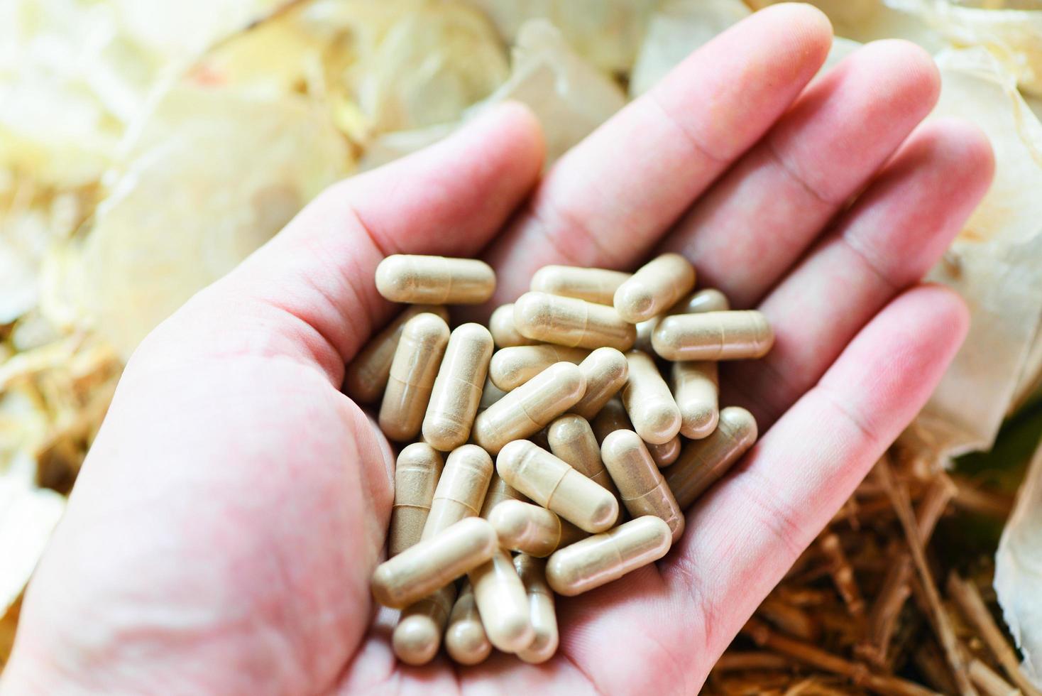 kruidencapsules van kruiden gezonde levensstijl - kruidengeneeskunde-extract uit de natuur niet-toxisch biologisch medicijnproduct bij de hand foto