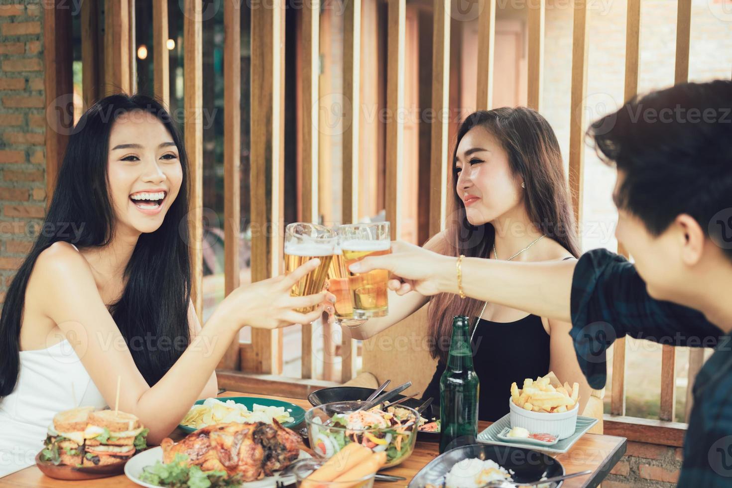 groep aziatische mensen juichen bier op restaurant happy hour in restaurant. foto