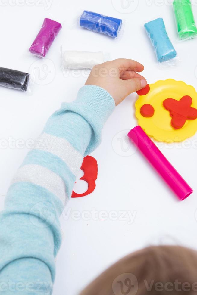 kinderhanden spelen deeg voor de creativiteit van kinderen. bordspel voor de ontwikkeling van fijne motoriek foto