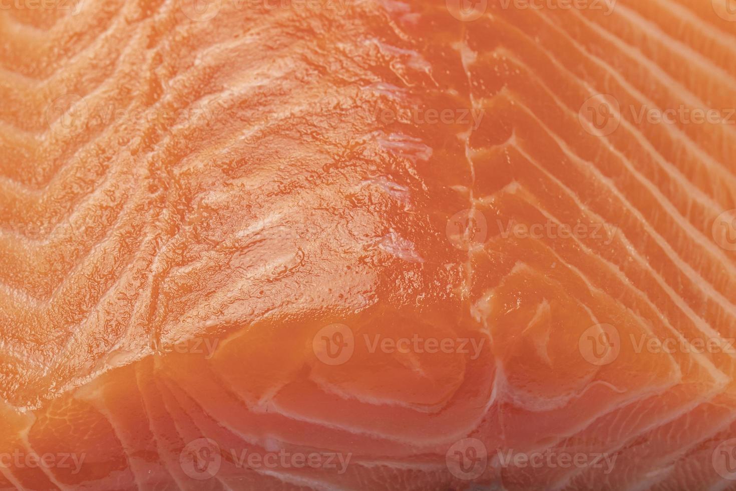 zalm vis oranje vlees met vette laag close-up textuur. foto