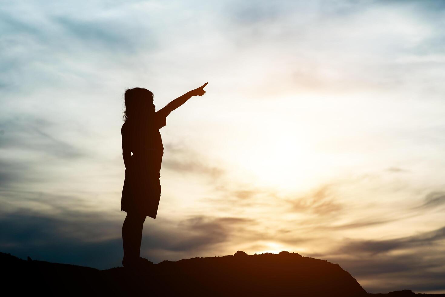 silhouet van meisje dat hand opsteekt naar vrijheid gelukkige tijd foto