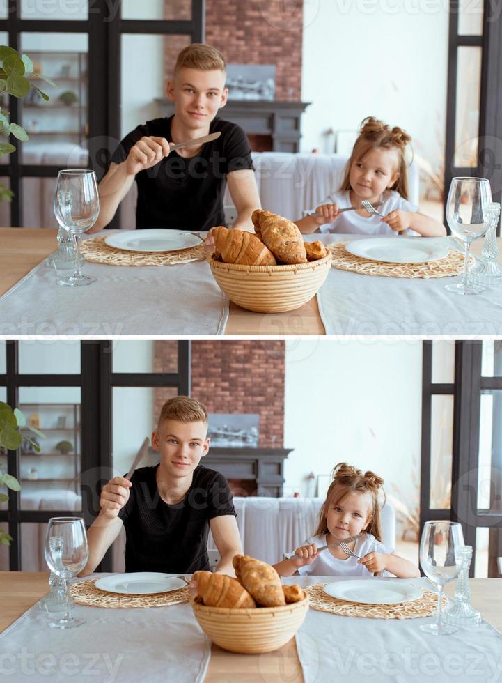 kaukasische grappige schattige broers en zussen - klein meisje met oudere broer in de eetkamer in een modern loft-interieur. familie, levensstijl en eetconcept foto