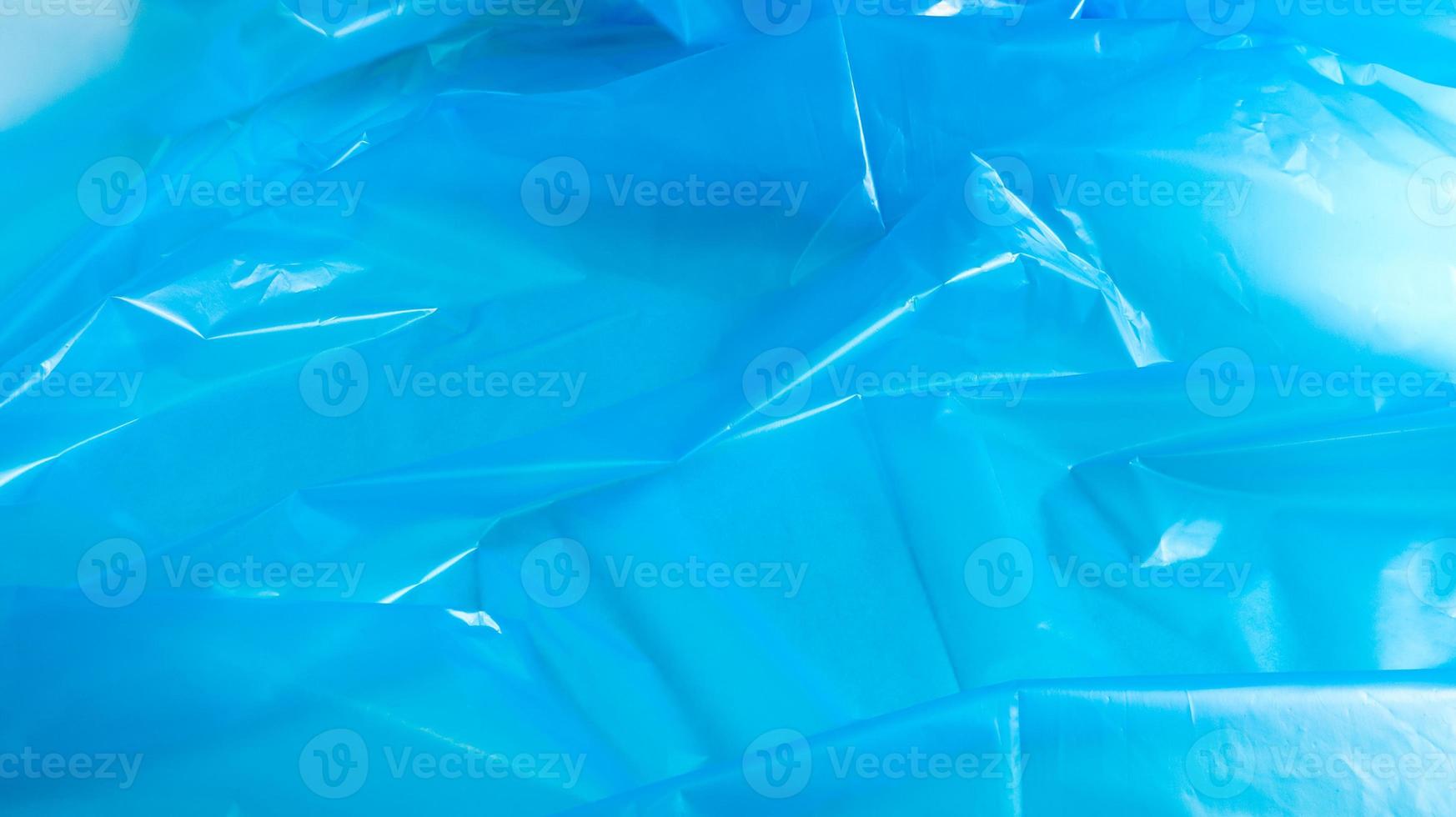 blauwe plastic zak textuur en achtergrond. een zak die is ontworpen om er afval in op te bergen en die thuis wordt gebruikt en in verschillende afvalcontainers wordt geplaatst. foto