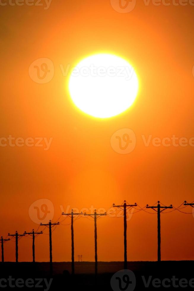 zon schijnt op lokale elektriciteitspalen foto