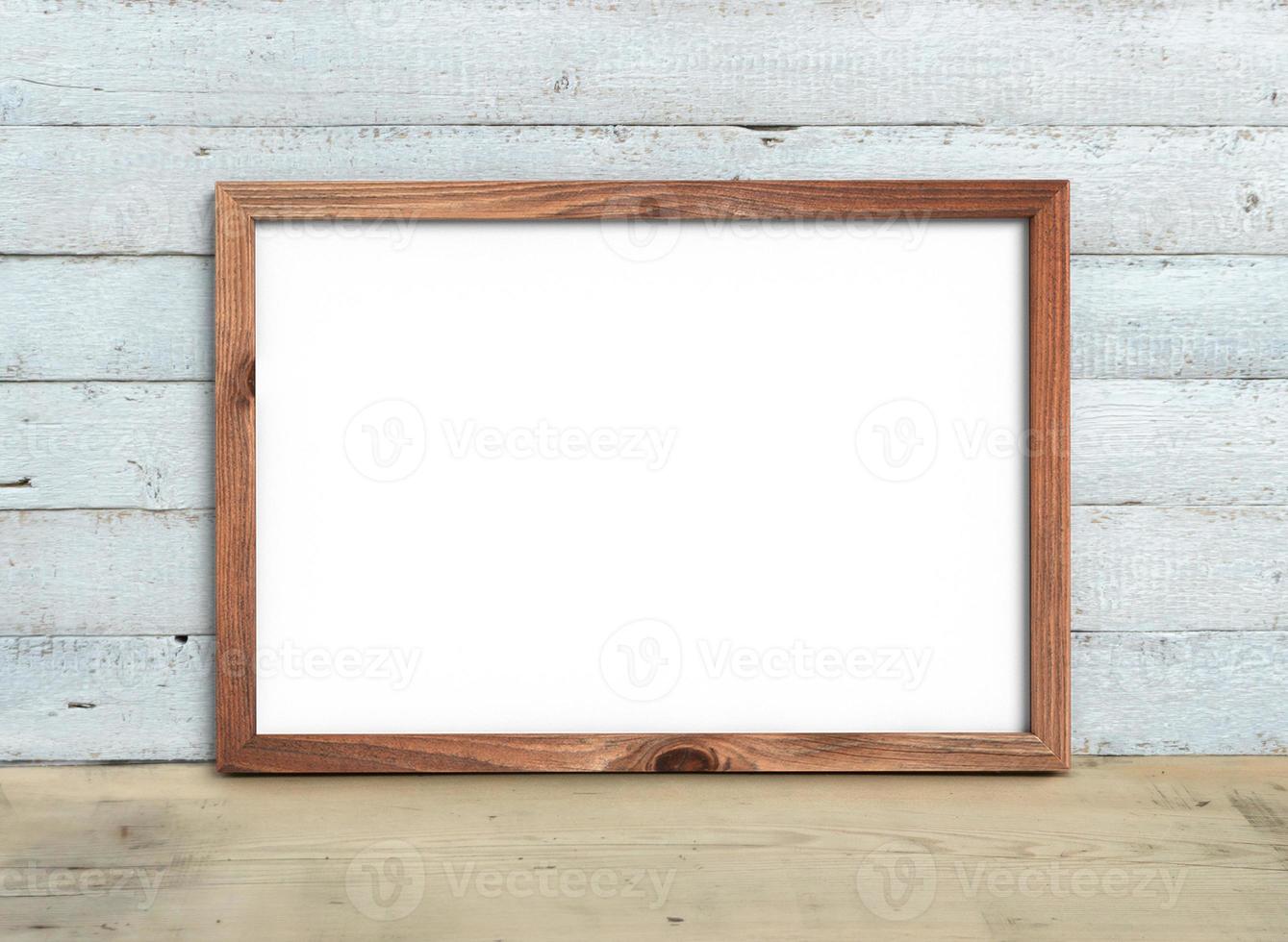 horizontale a4 oude houten frame mockup staat op een houten tafel op een geschilderde witte houten achtergrond. rustieke stijl, eenvoudige schoonheid. 3D render. foto