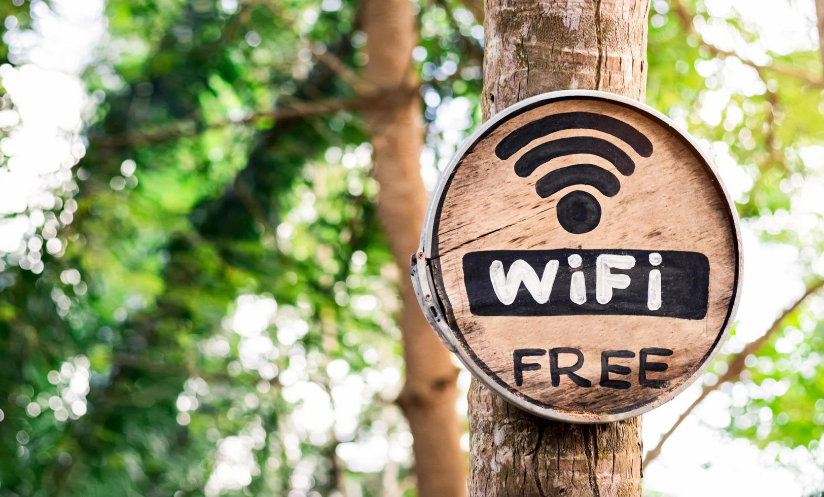 gratis wifi-bericht op rond houten bord en een bord in de buitentuin bij de coffeeshop. foto