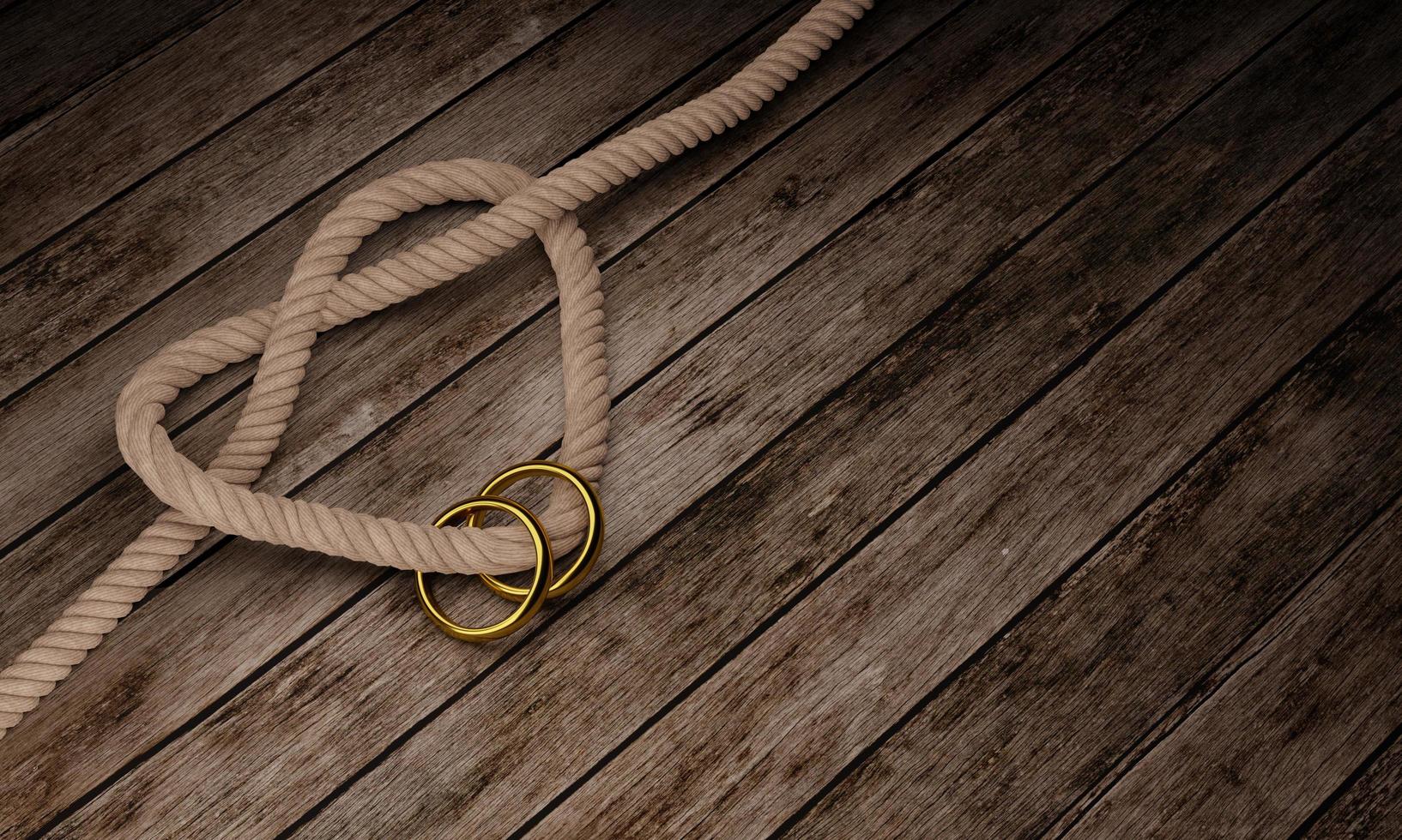 hartvormige touwknoop en gouden ring op houten oppervlak en plank. kopieer ruimte en concept voor foto