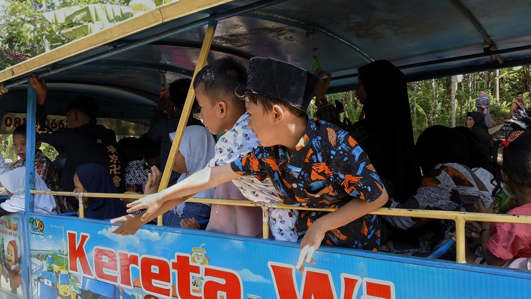 20 maart 2022 in het regentschap Cianjur, West-Java, Indonesië, rijden kinderen in een odong-odong-auto. odong-odong is een ritje met muntautomaat voor kleine kinderen foto