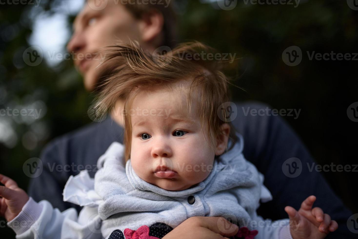 jonge vader die plezier heeft met zijn dochtertje in het park foto