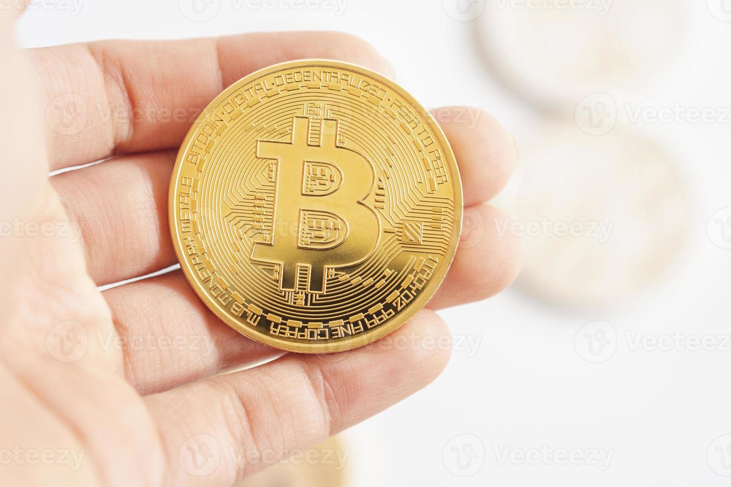 hand met gouden bitcoins of cryptocurrency-symbool op witte achtergrond. foto