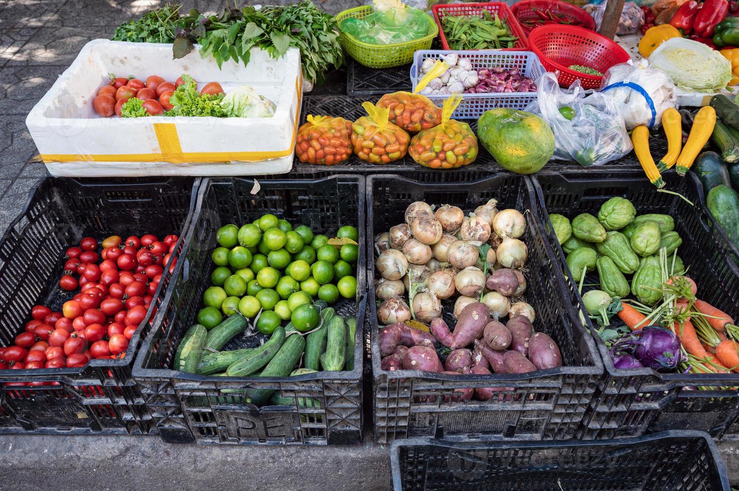 verschillende groenten en fruit in mand die op kruidenierswinkelkraam verkopen foto