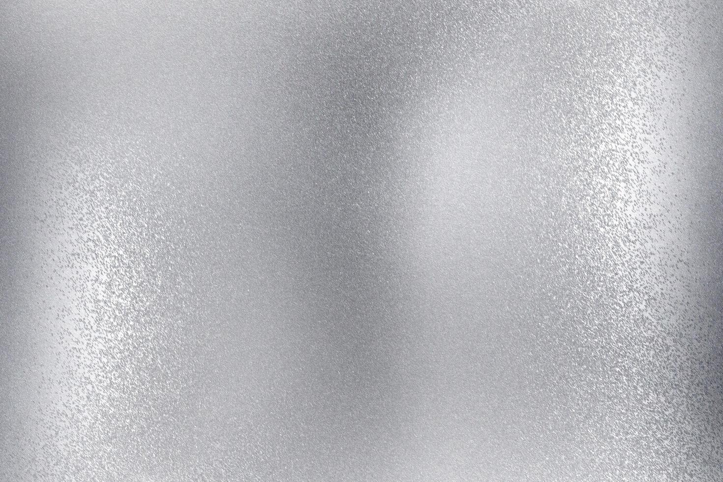 glanzende geborstelde zilveren metalen wand, abstracte textuurachtergrond foto